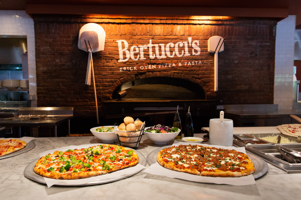 Pizza in front of a brick oven